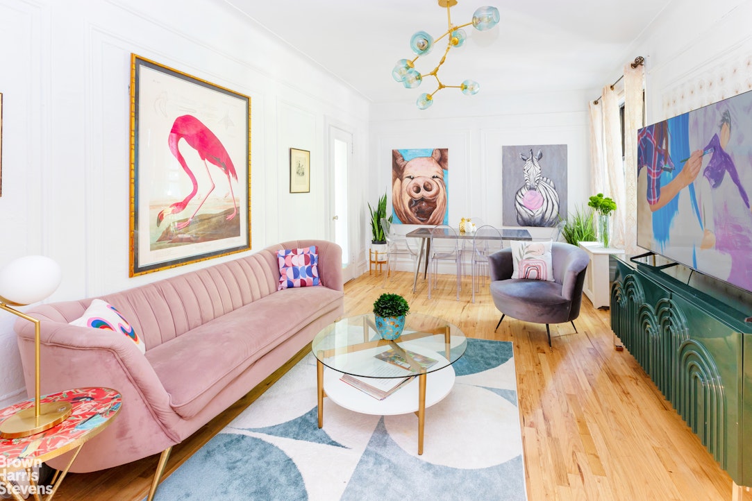 a living room with furniture and a wall painting