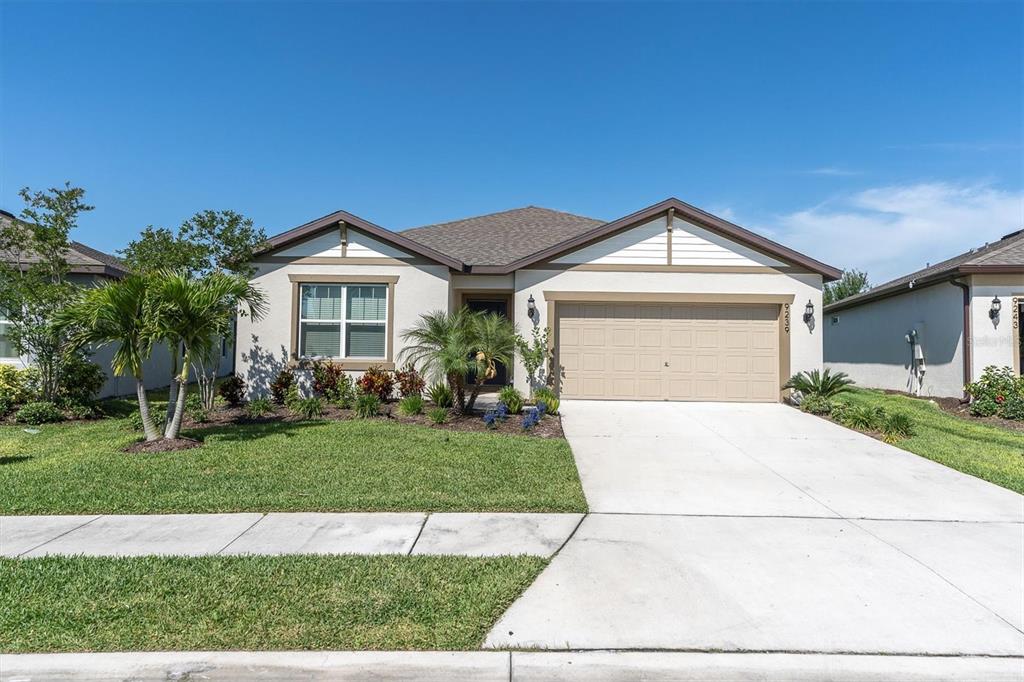 a front view of a house with a yard and garage