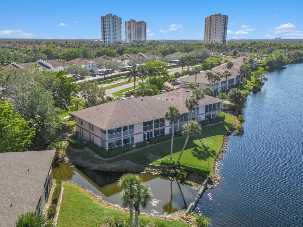 an aerial view of a house with a garden and lake view