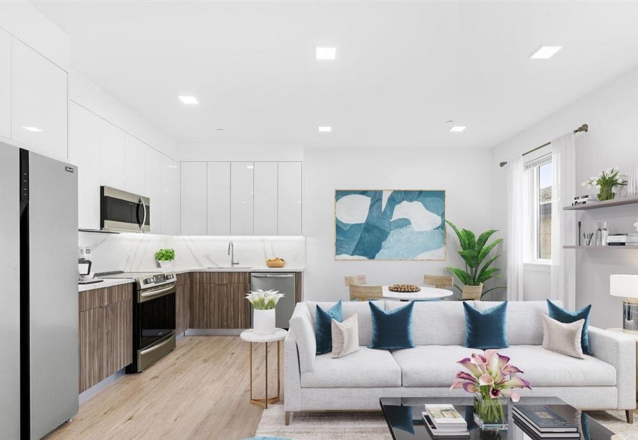 a living room with furniture and kitchen view