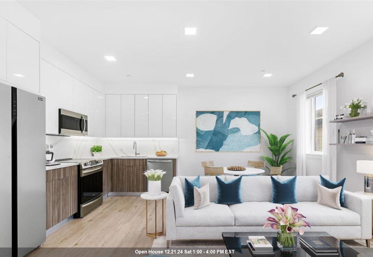 a living room with furniture and kitchen view