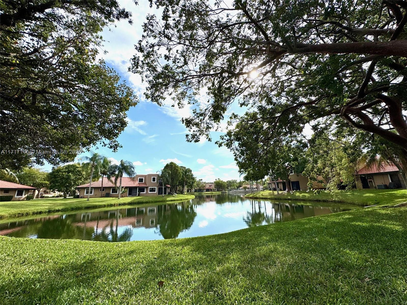 a view of a lake with houses in the background