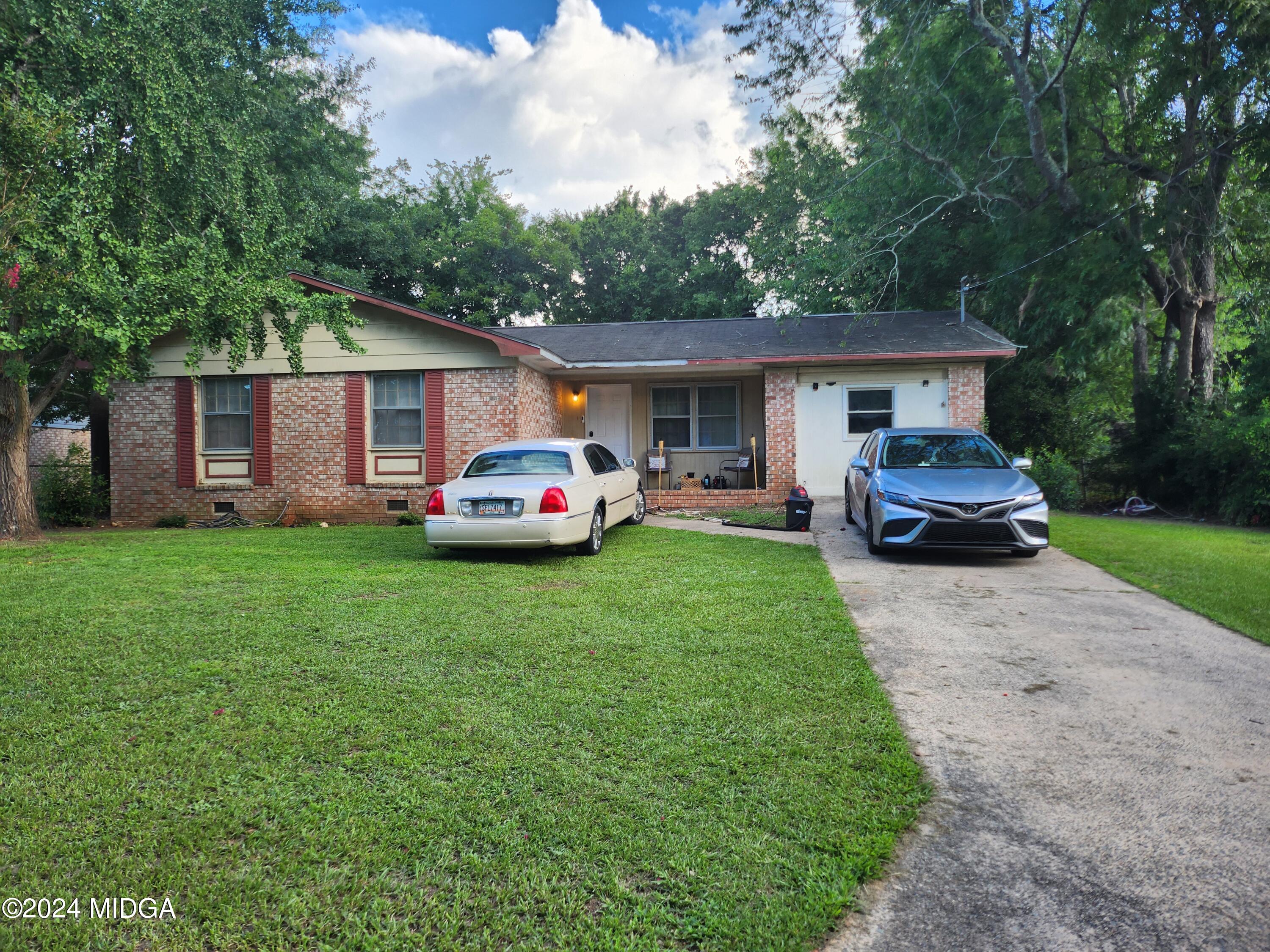 a front view of house with yard and green space