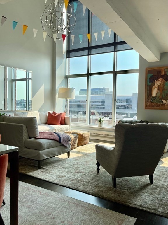 a living room with furniture and a floor to ceiling window