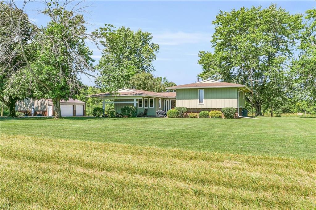 a front view of house with yard and trees