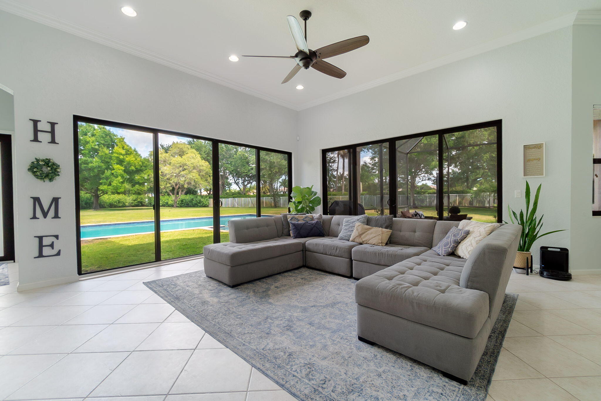 a living room with furniture and large windows