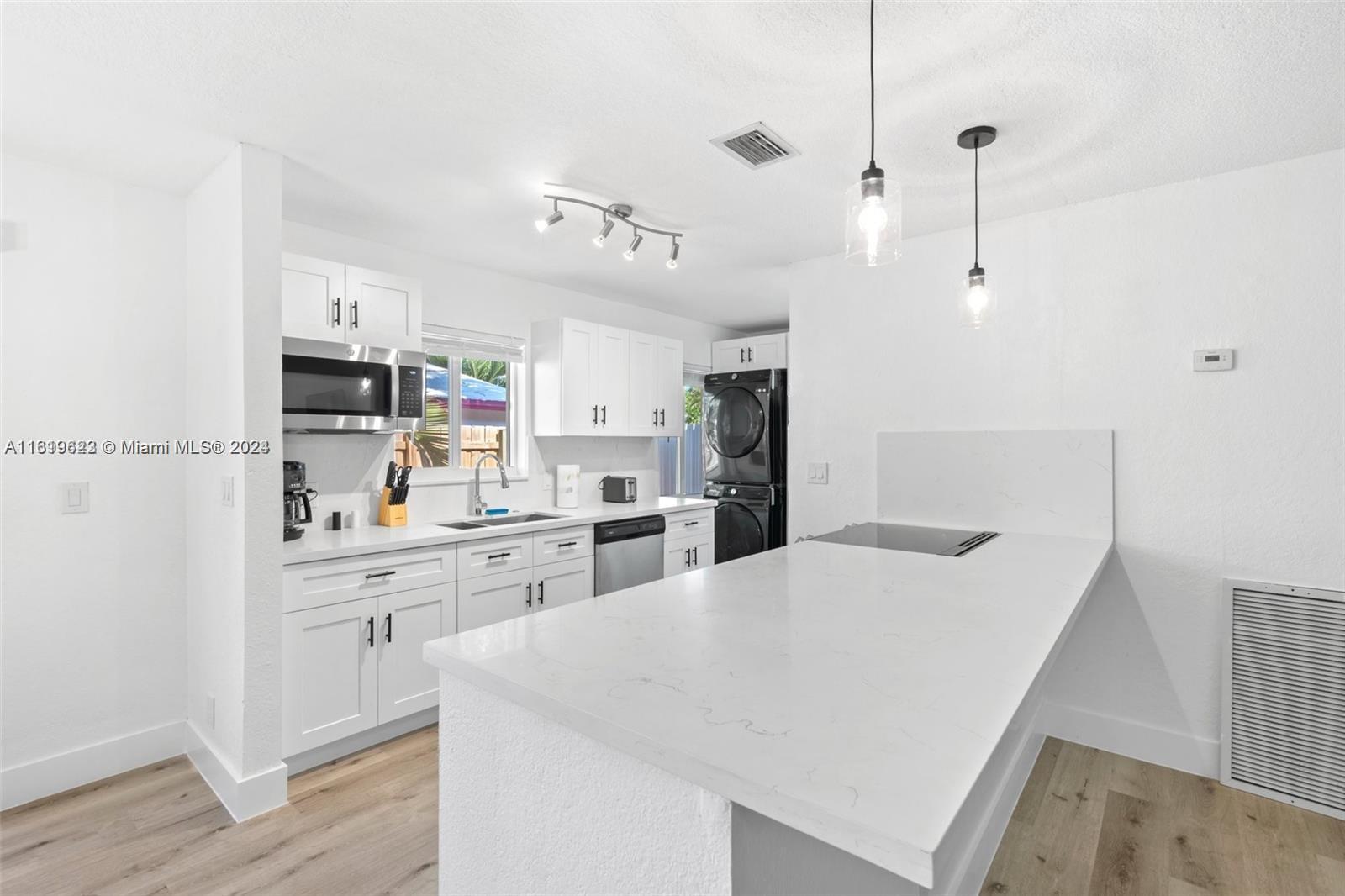 a kitchen with refrigerator and cabinets