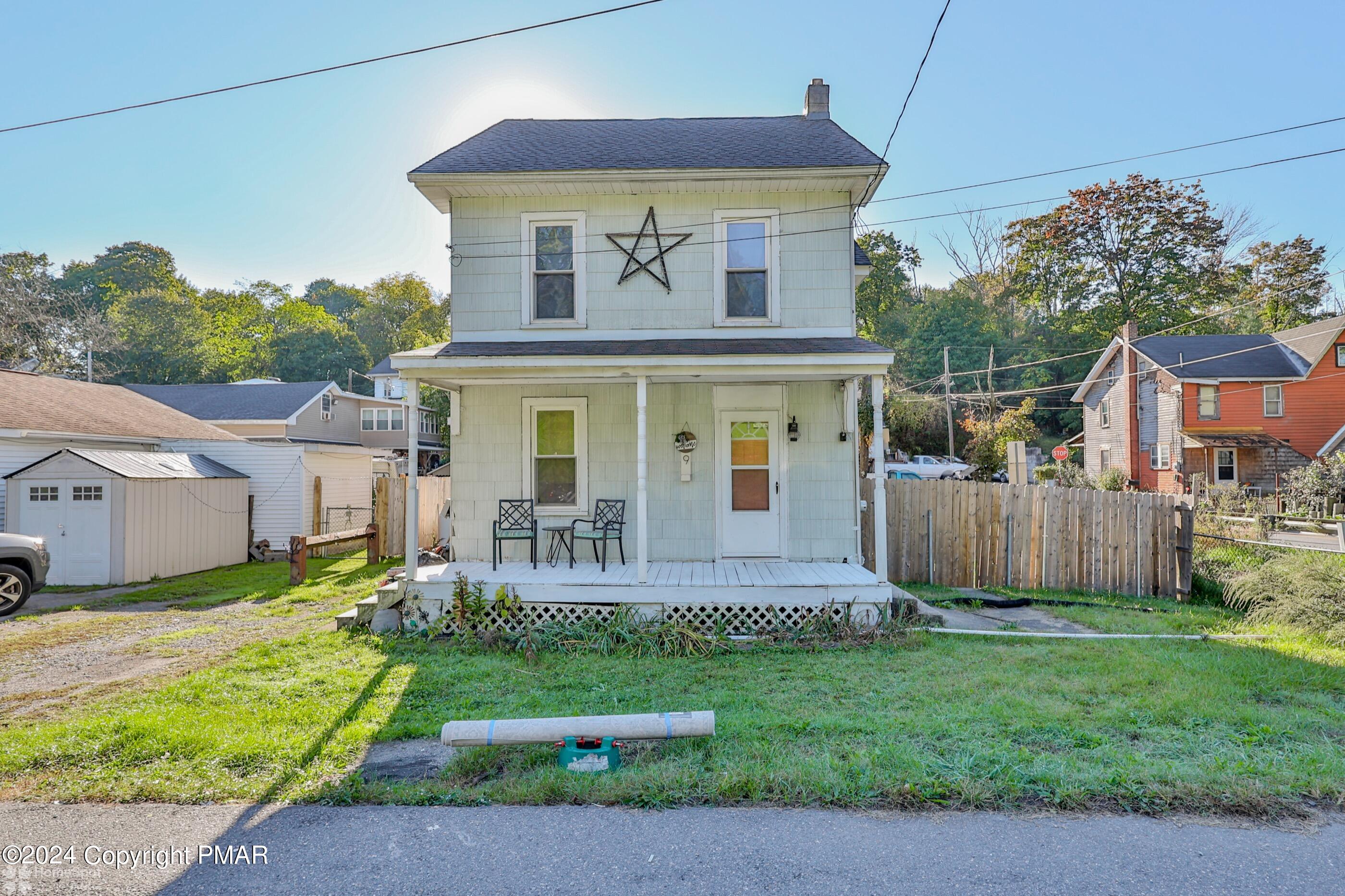 a front view of a house with a yard table and chairs