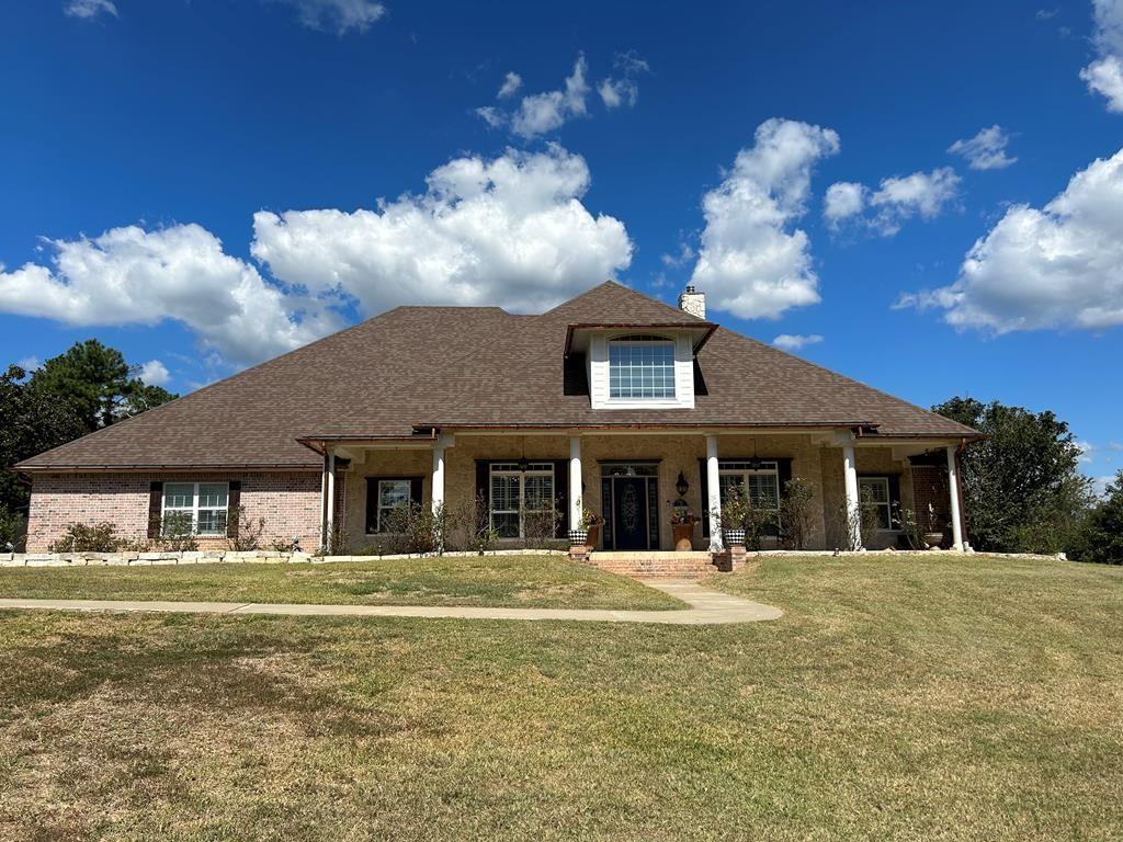 a front view of a house with a garden