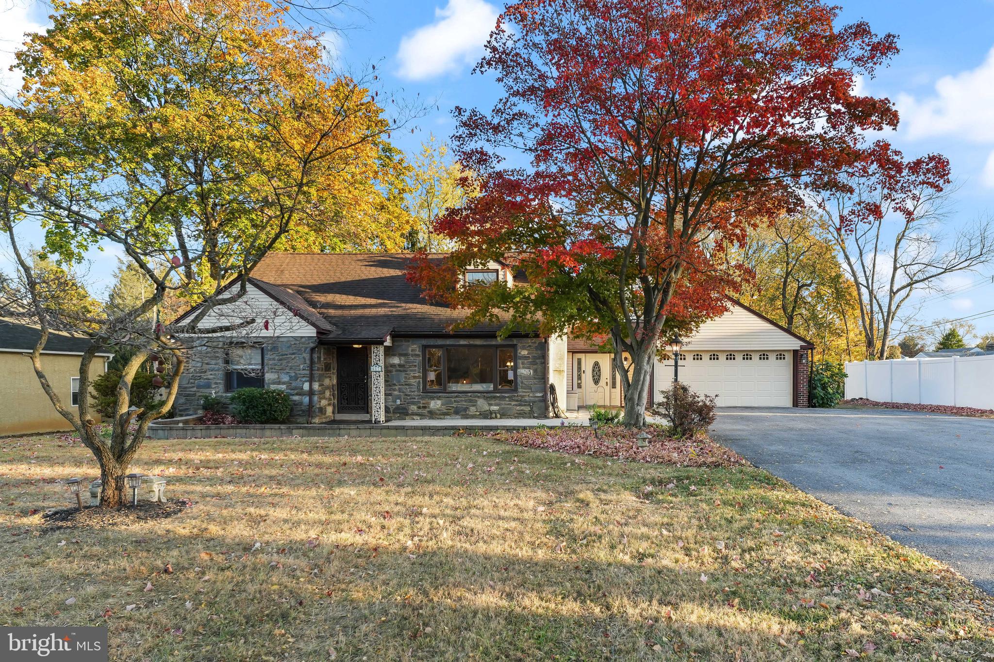 a front view of a house with a tree