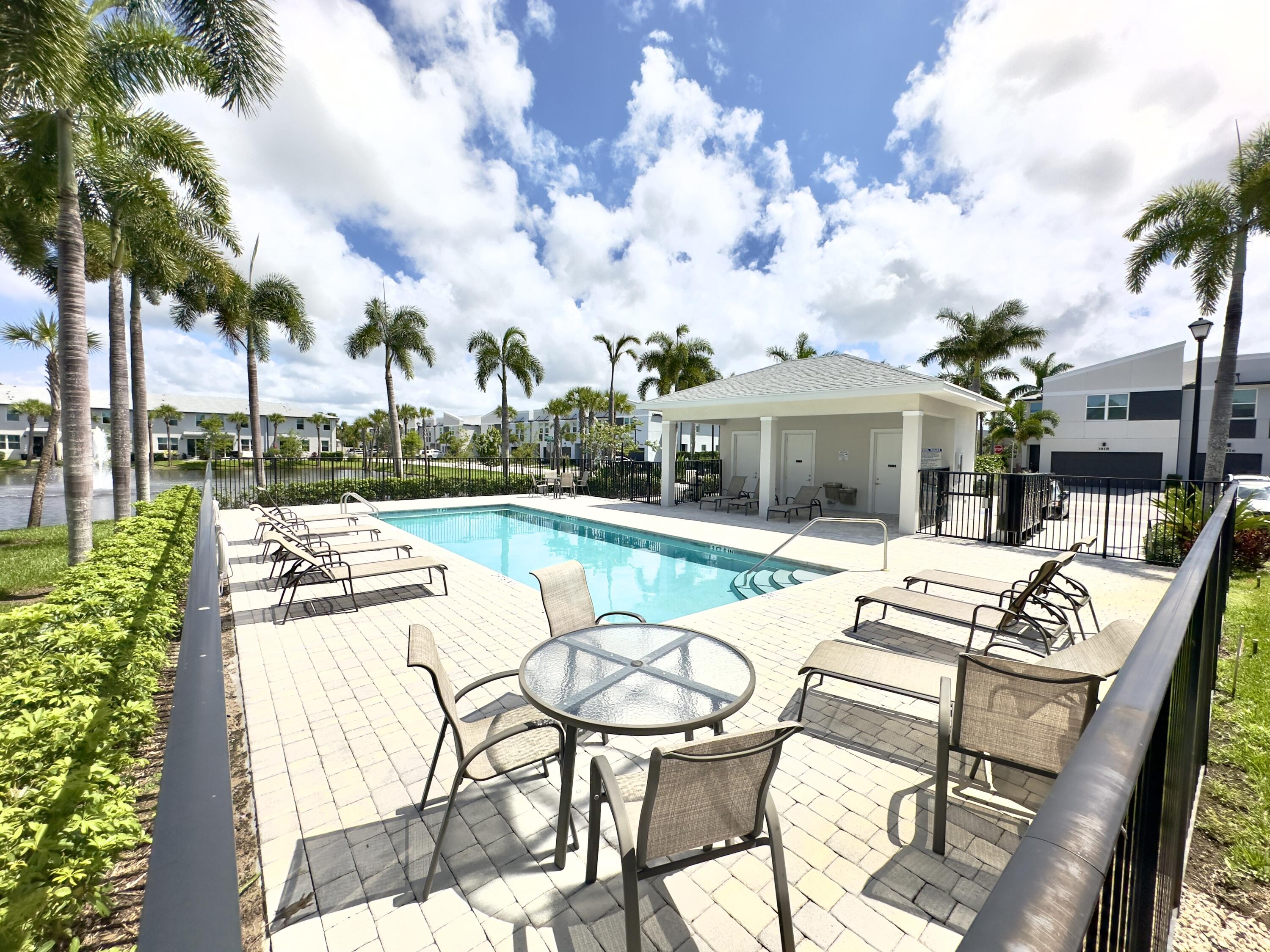 a view of a house with swimming pool and sitting area