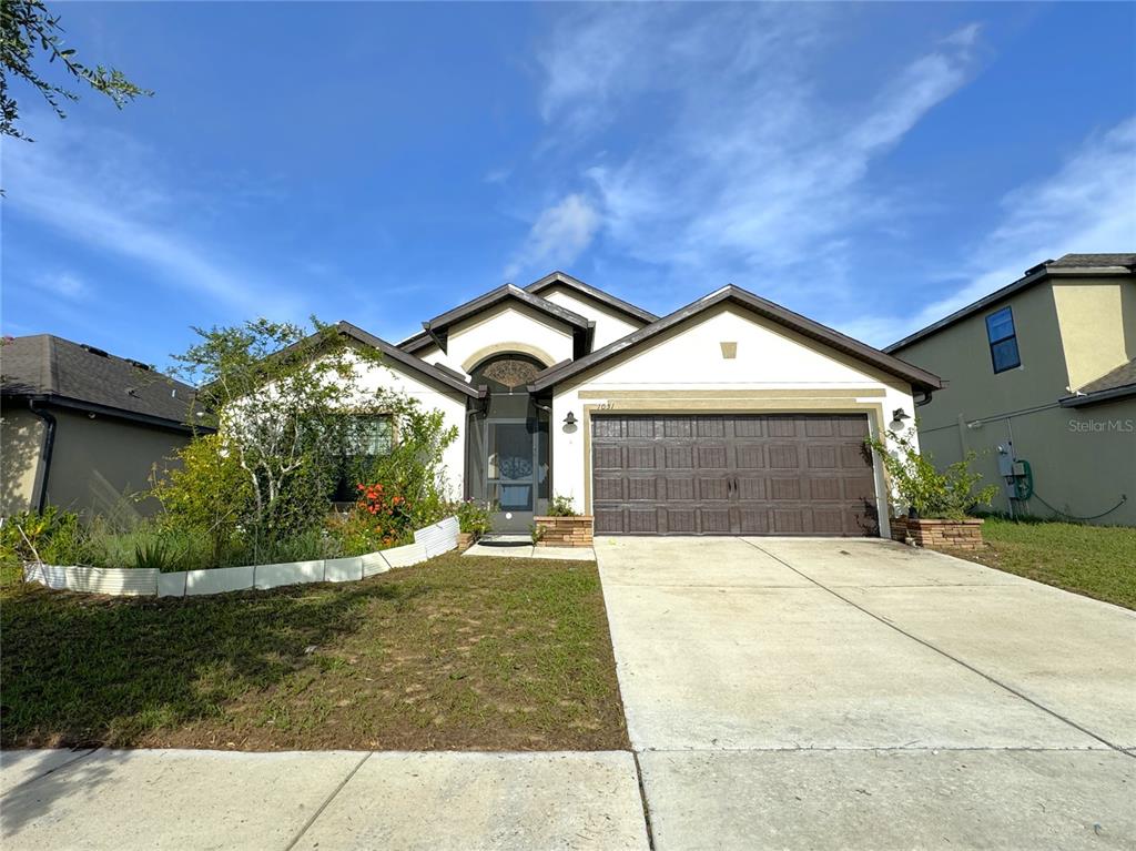 a front view of a house with a yard and garage