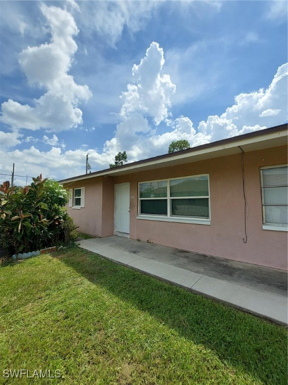 a view of house with backyard