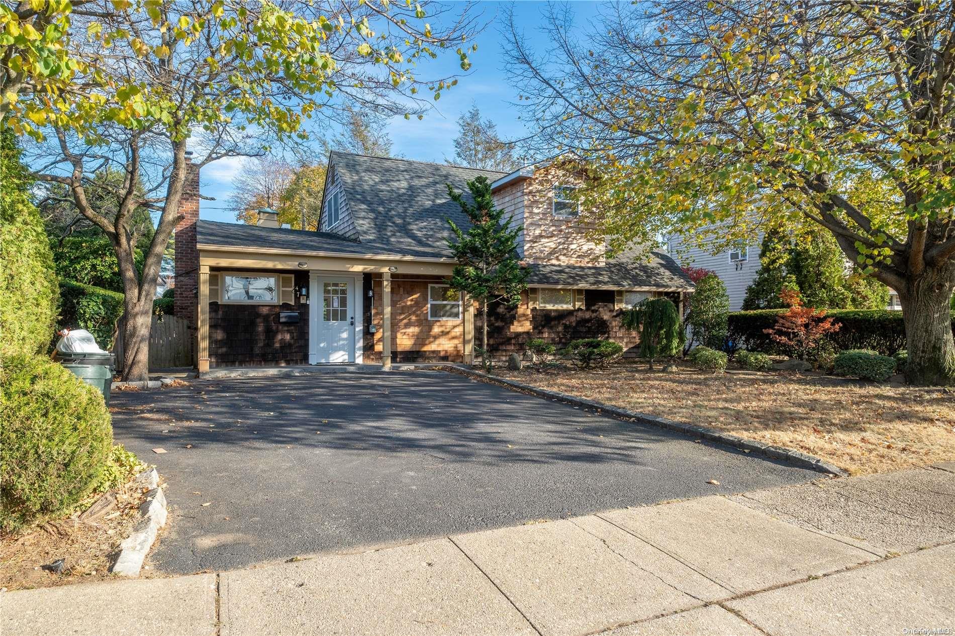 front view of a house with a tree