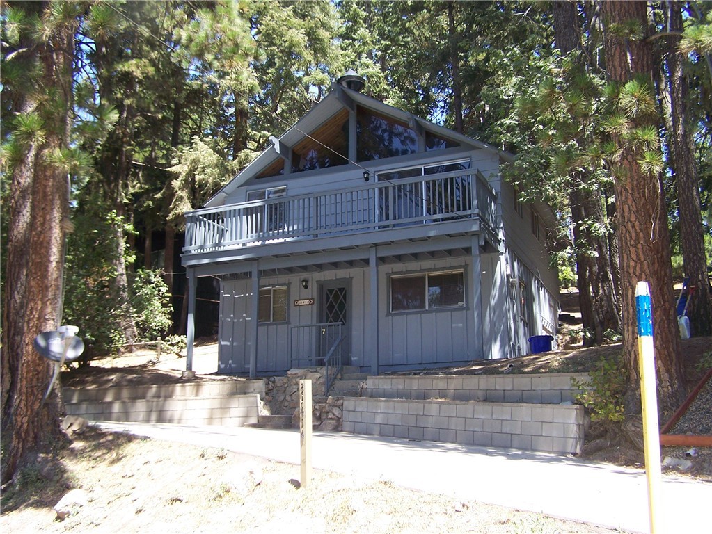 a front view of a house with a yard covered with snow