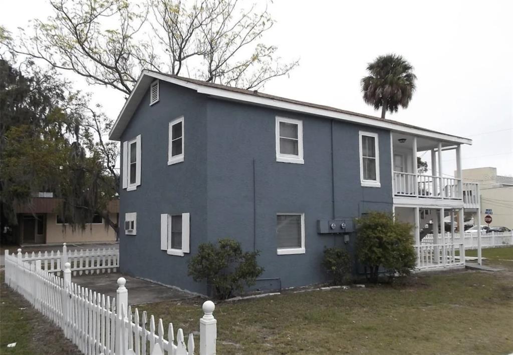 a front view of house with yard and trees