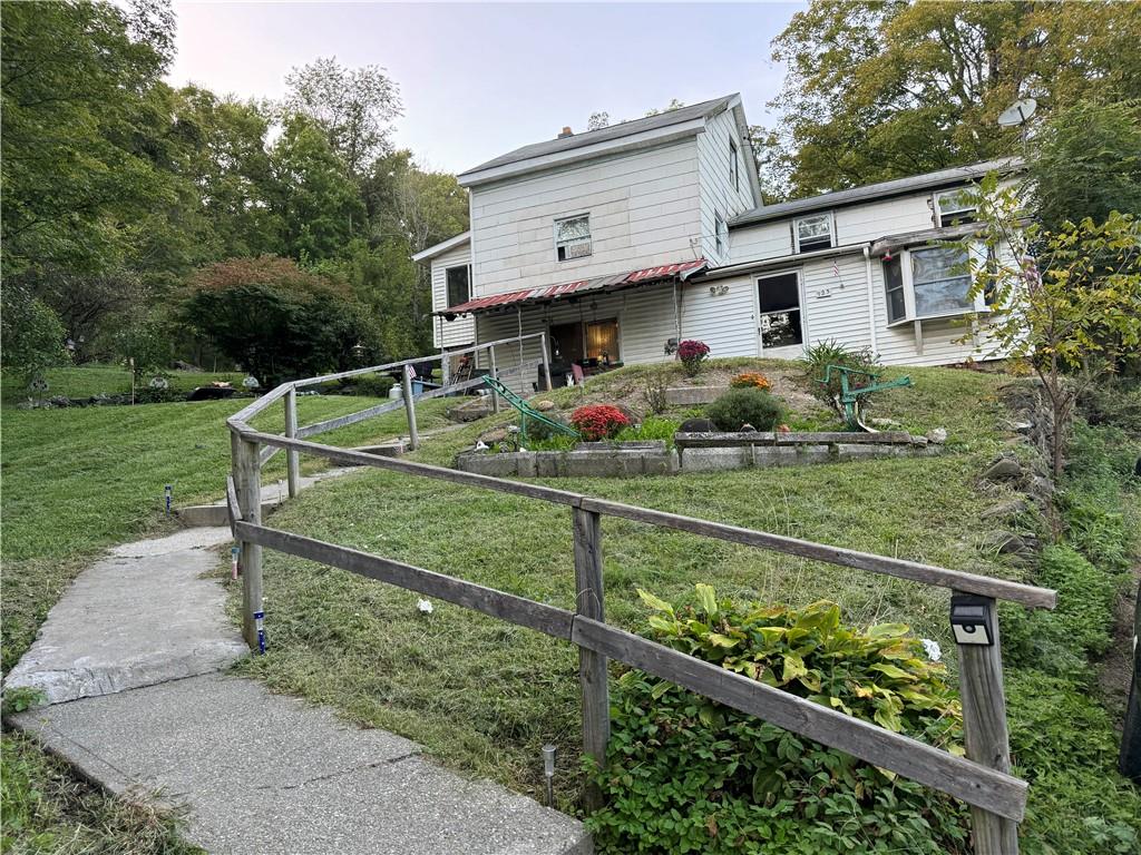 a view of a house with backyard and sitting area