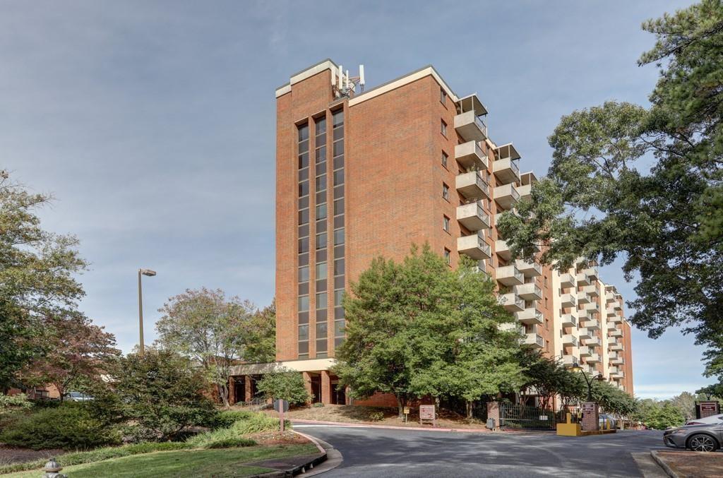 a view of a tall building next to a road