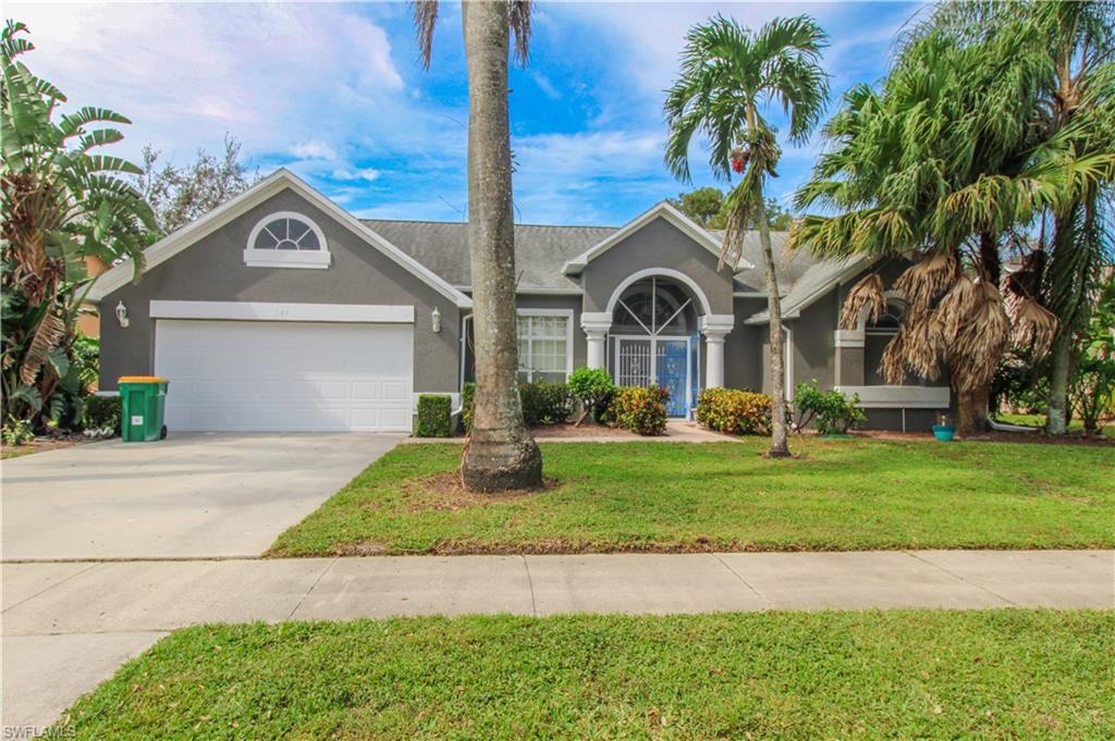 Ranch-style house featuring a front lawn and a garage