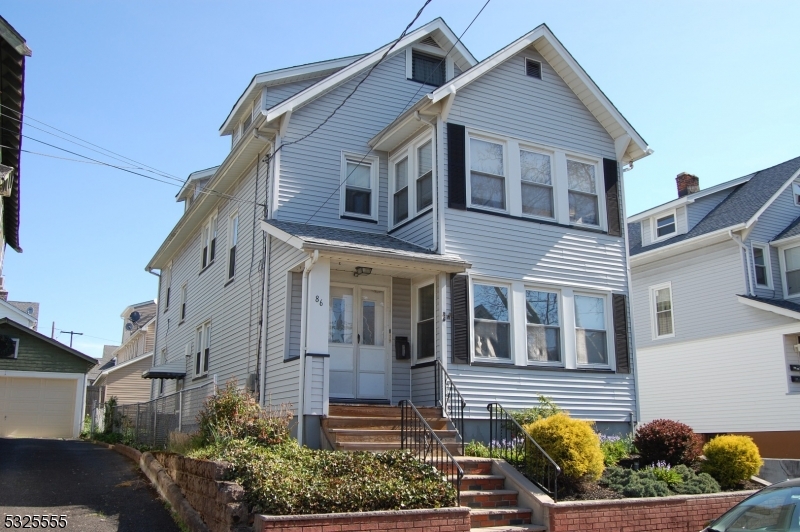 a front view of a house with a garden