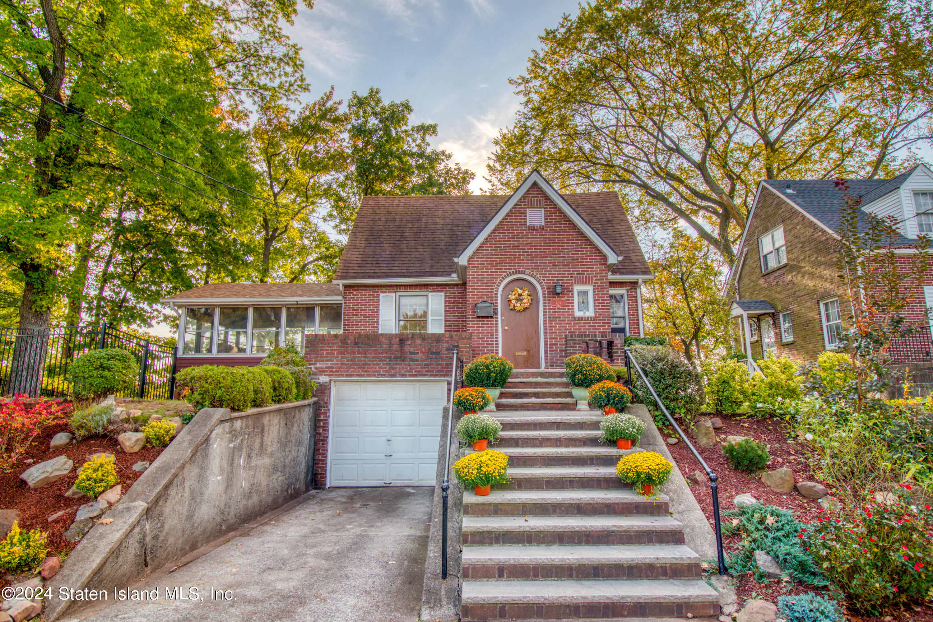 a front view of a house with a garden