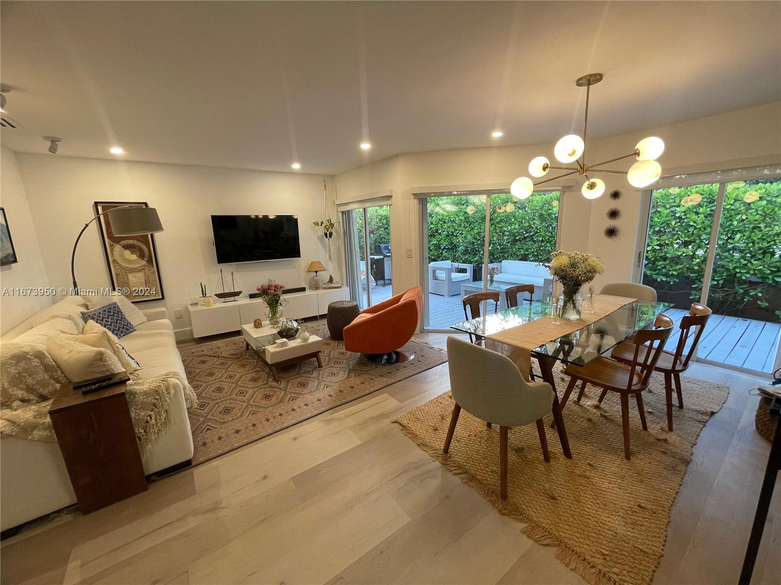 a living room with furniture a window and a flat screen tv