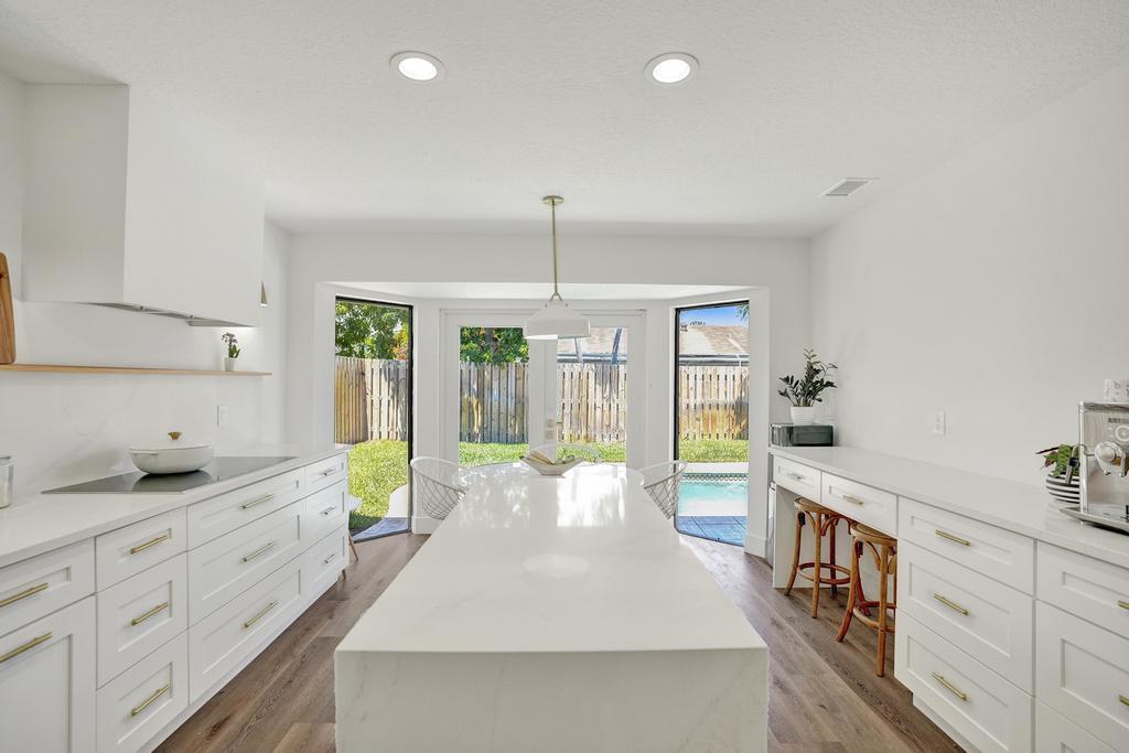 a large white kitchen with a large window