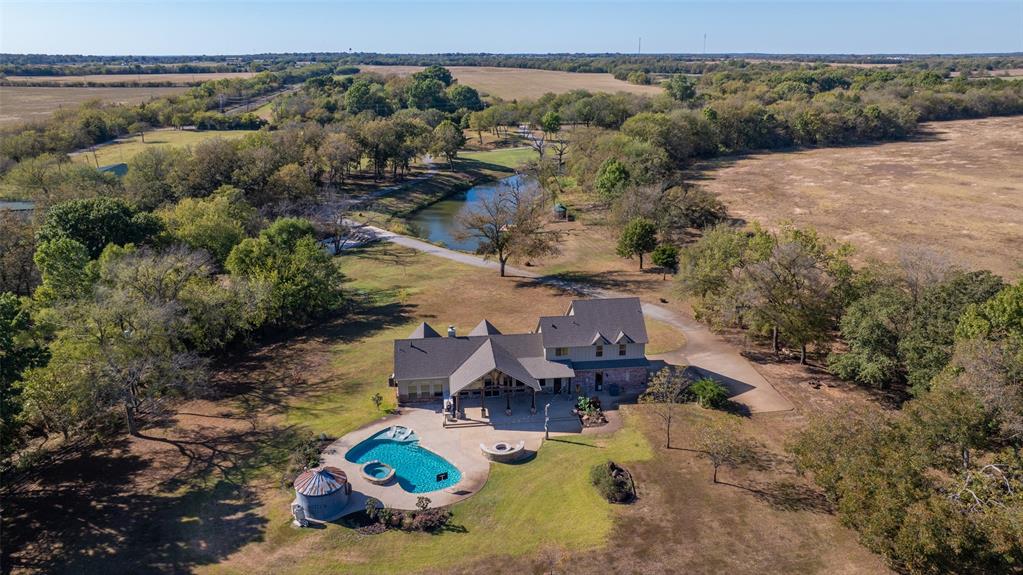 an aerial view of a house with yard swimming pool and mountain view