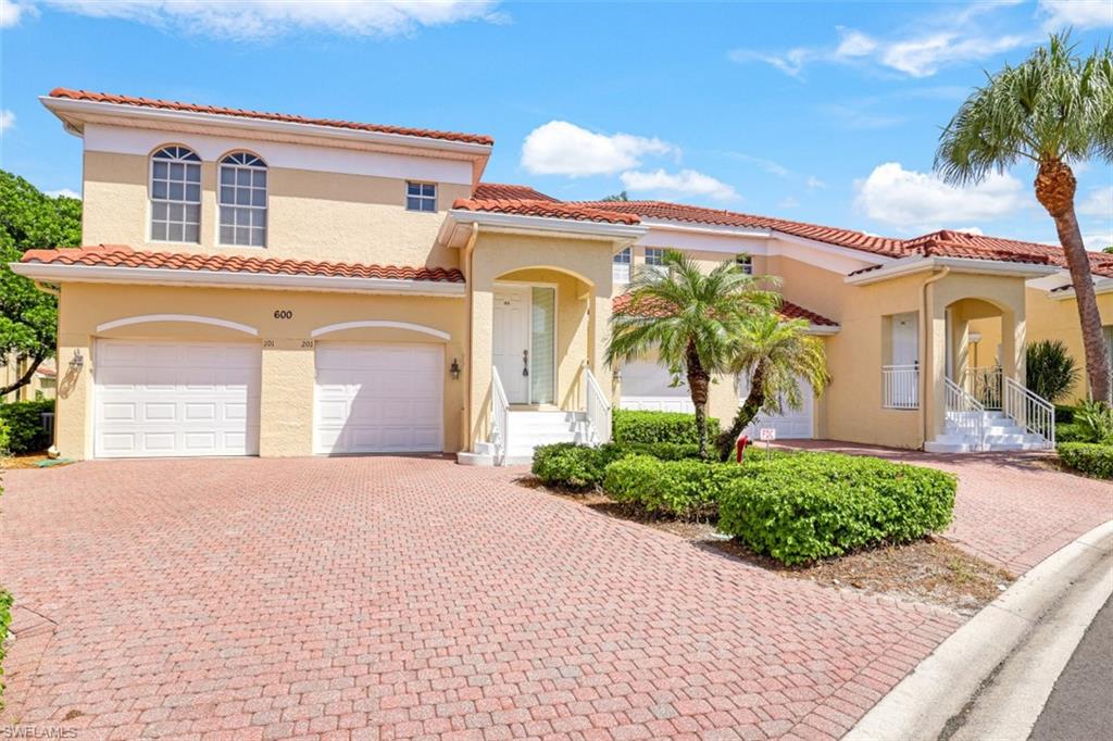 a front view of a house with a yard and a garage