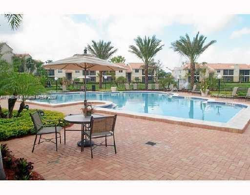 a view of a swimming pool with a table and chairs