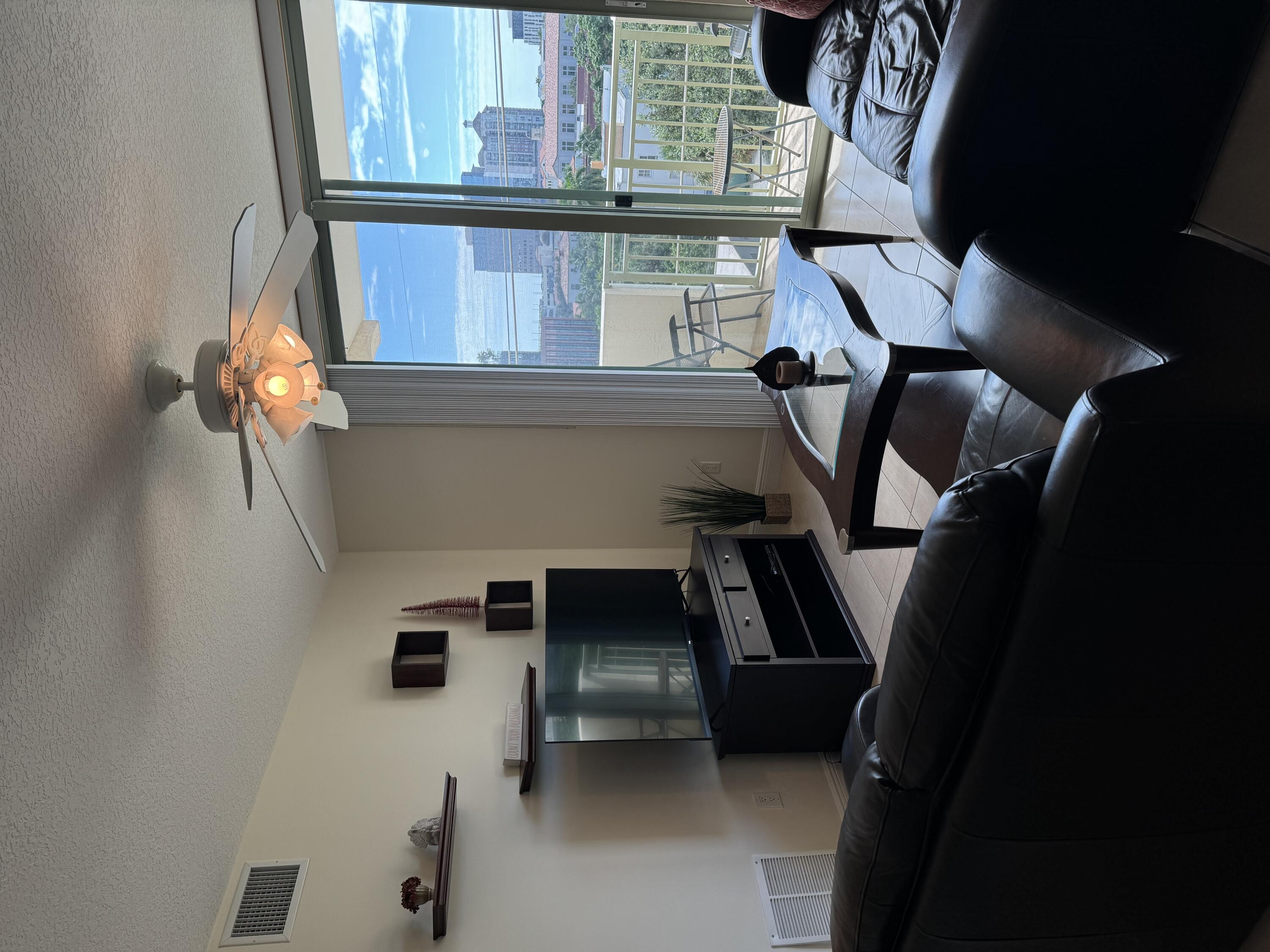 a living room with furniture and a floor to ceiling window