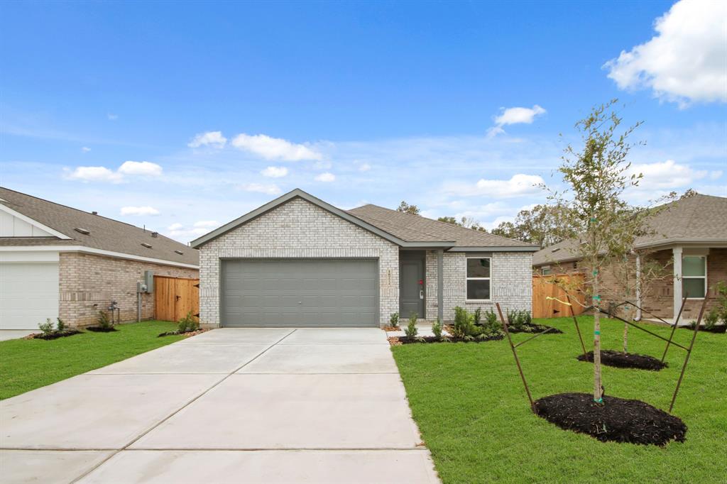 a front view of house with yard and green space