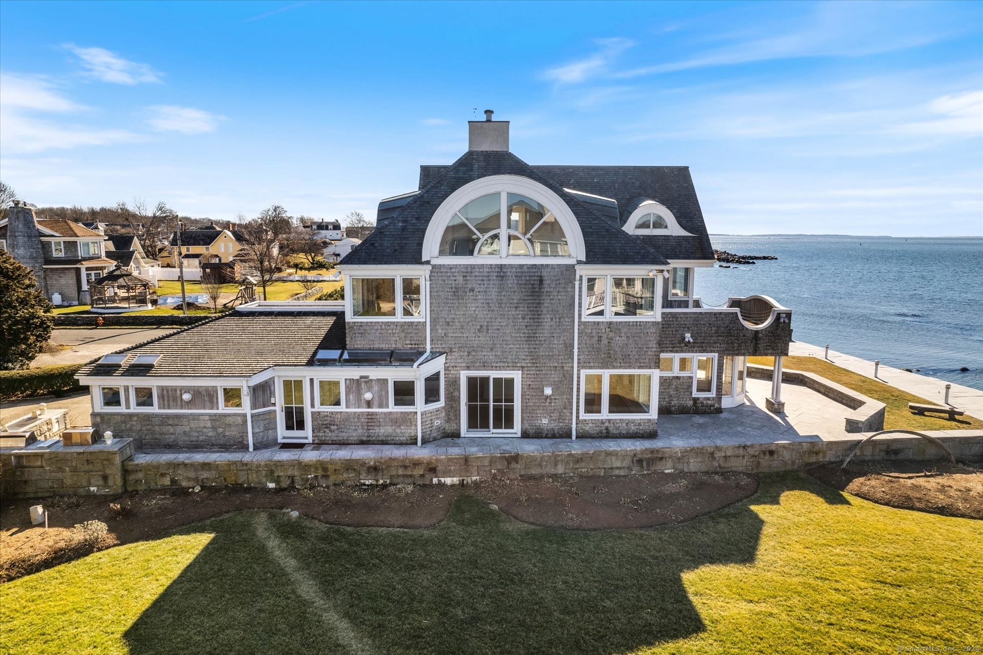 an aerial view of a house with swimming pool and lake view