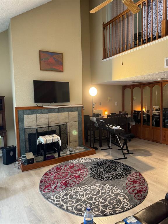 a living room with furniture a fireplace and a flat screen tv