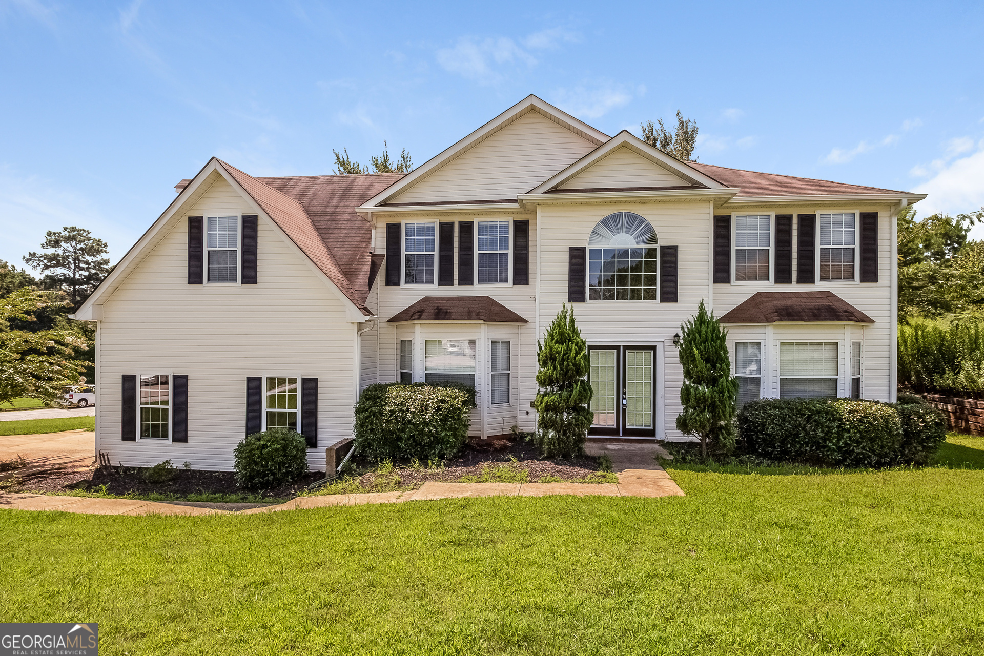 a front view of a house with a yard