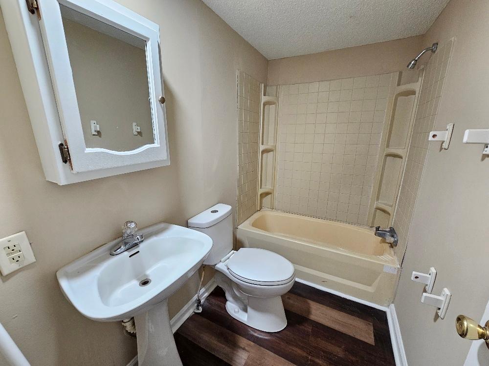 a bathroom with a sink a toilet and a bathtub