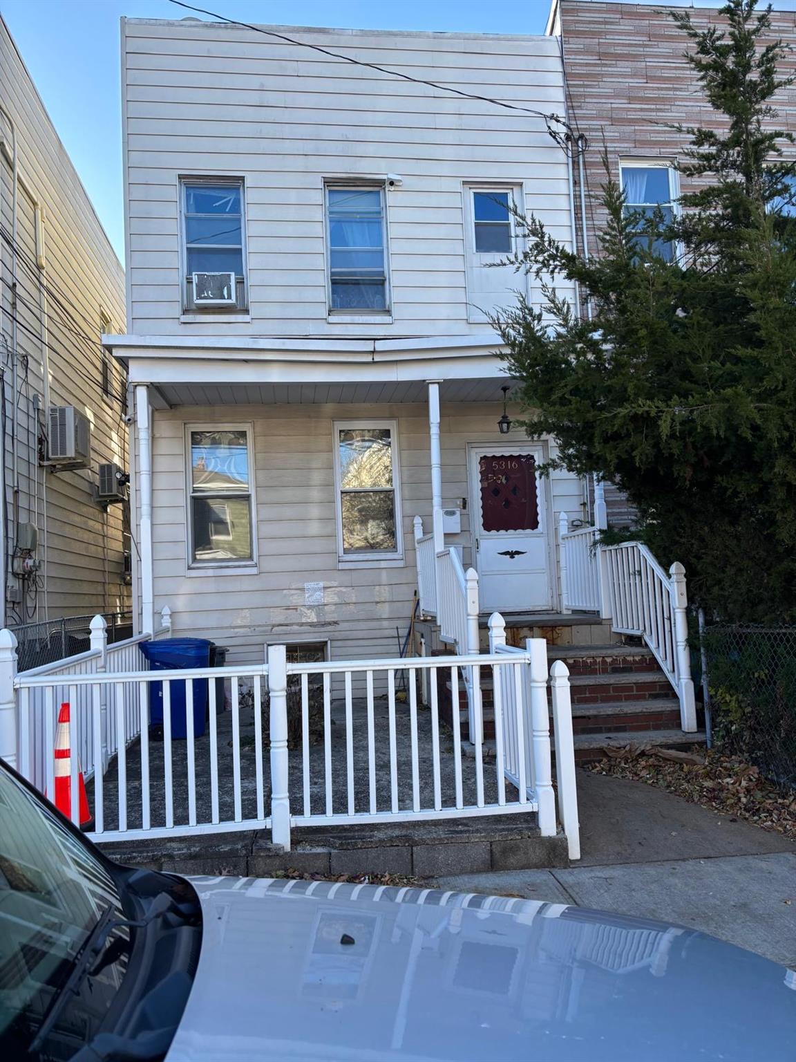 a view of a house with wooden fence