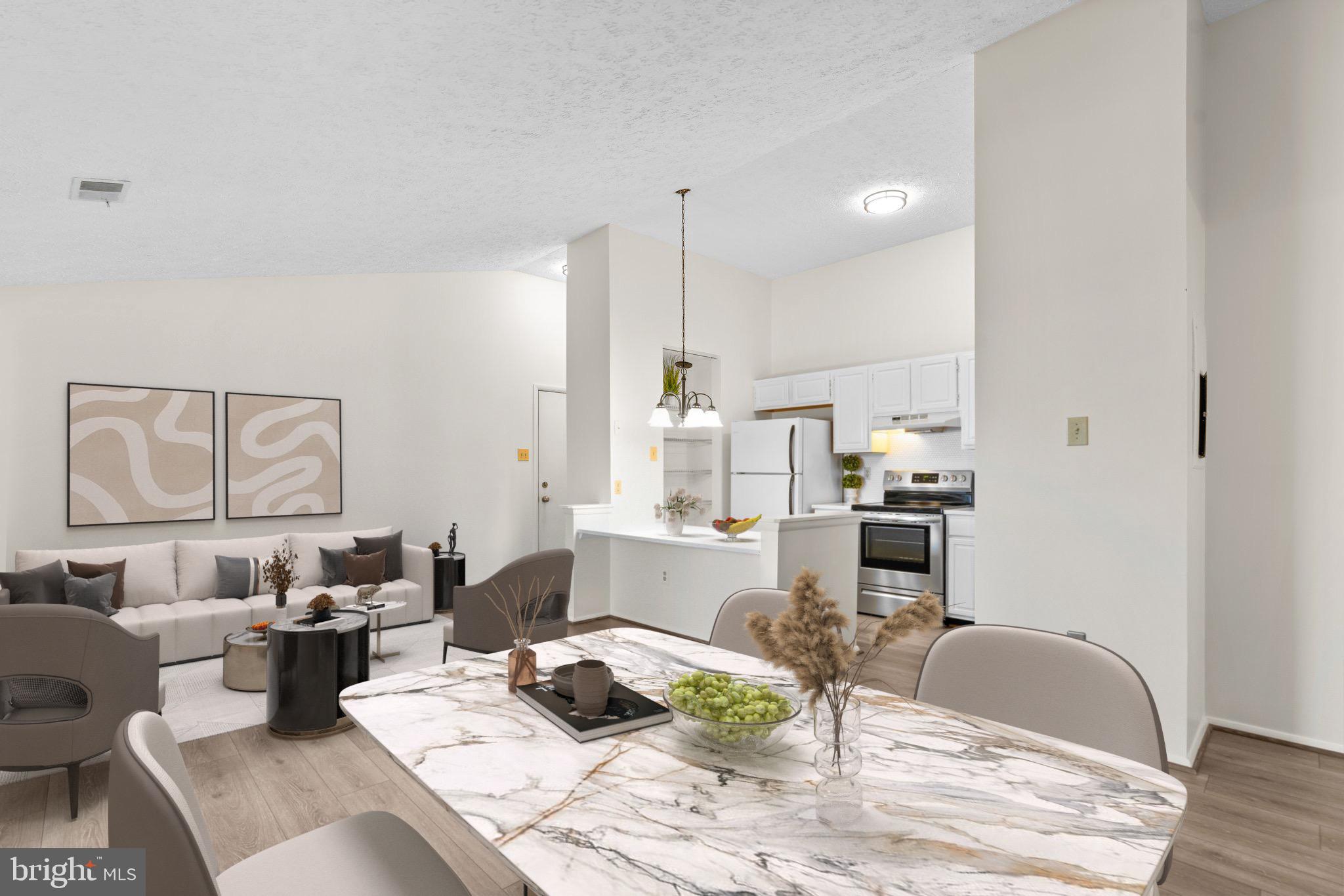 a living room with furniture kitchen view and a wooden floor