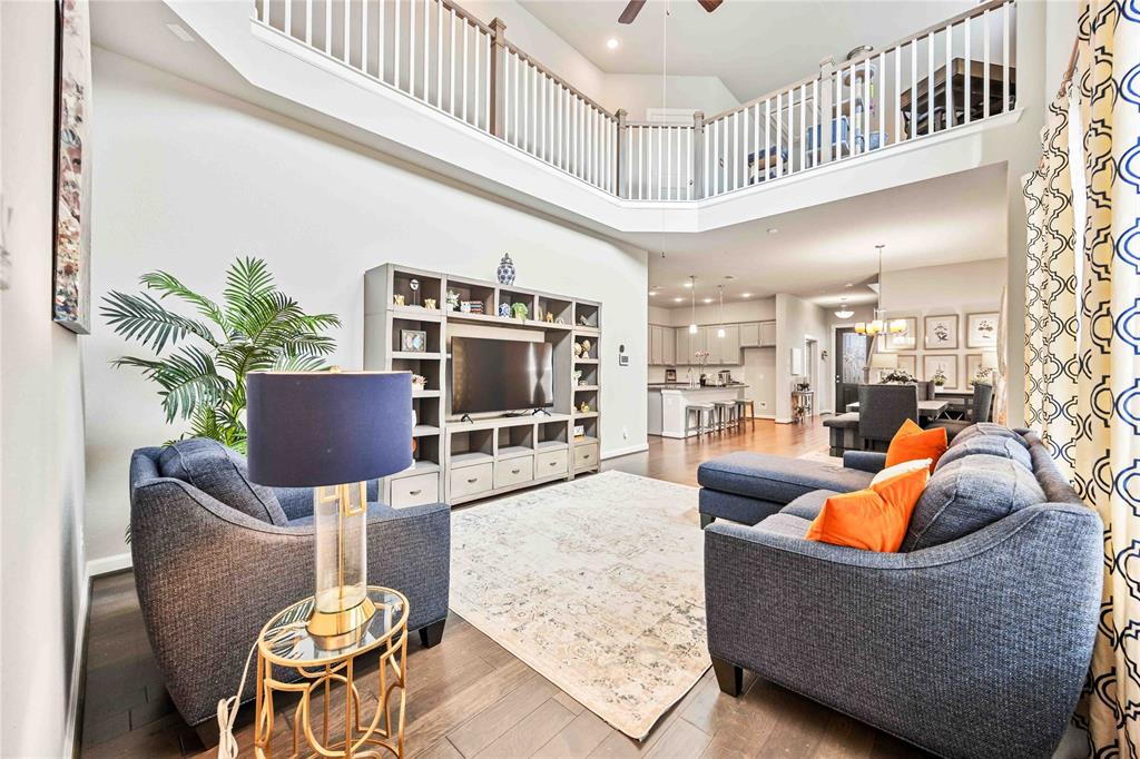 a living room with furniture a flat screen tv and couches