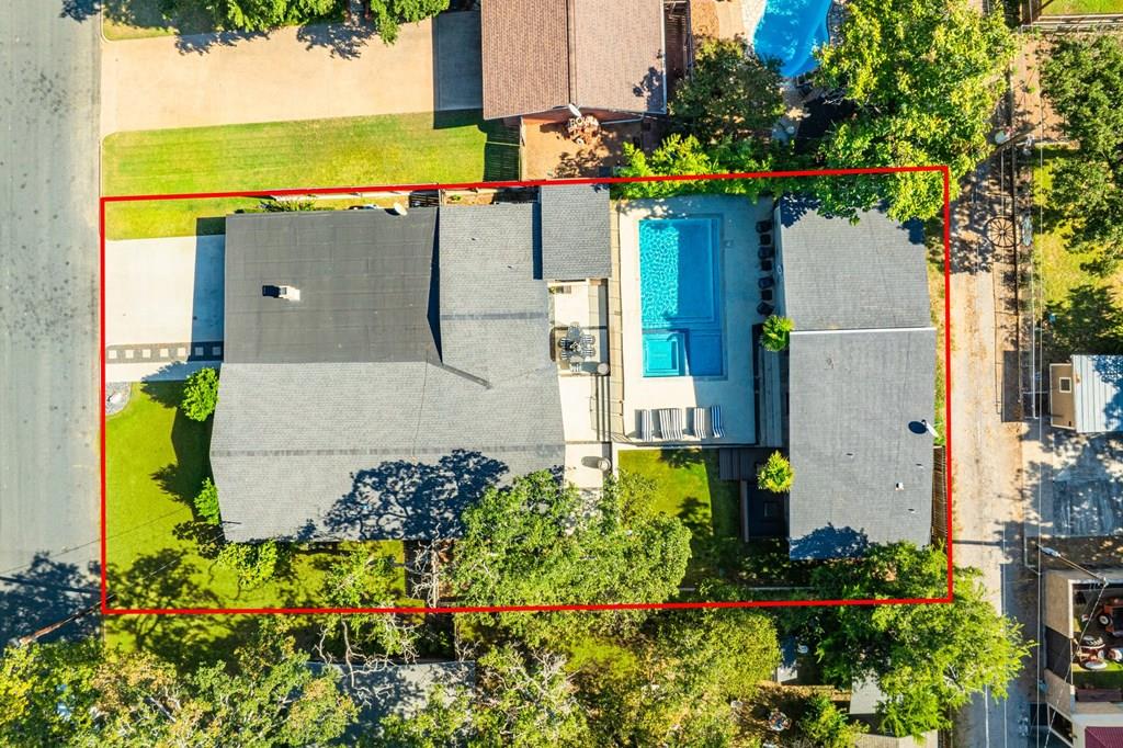 an aerial view of a house with a garden and a yard