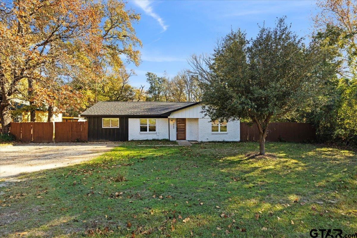 a house with huge green field in front of it