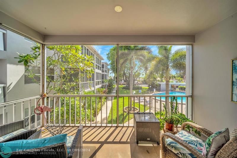 a balcony with furniture and garden view