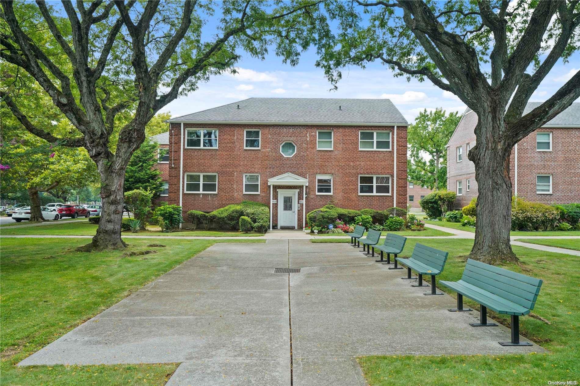 a front view of a house with a yard table and chairs