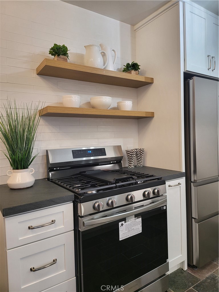 a stove top oven sitting inside of a kitchen