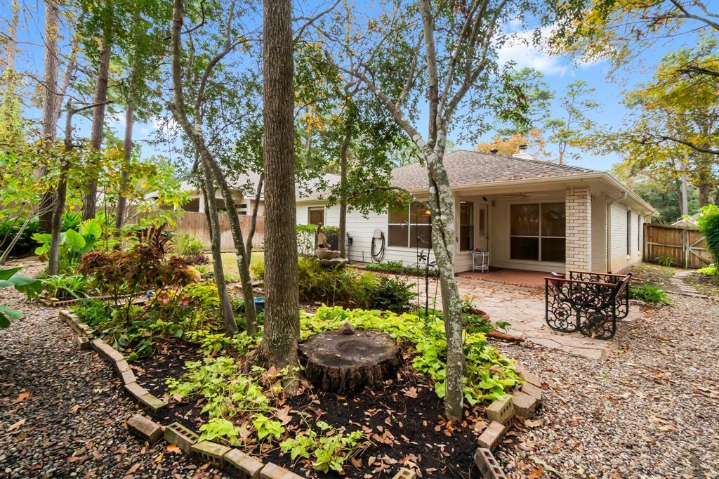 a view of a house with backyard sitting area and garden