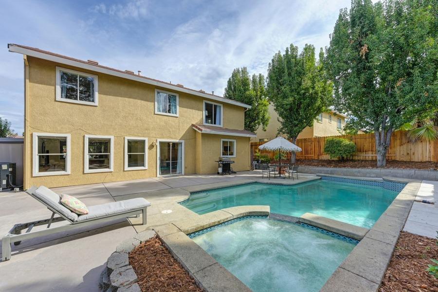 a front view of a house with swimming pool having outdoor seating