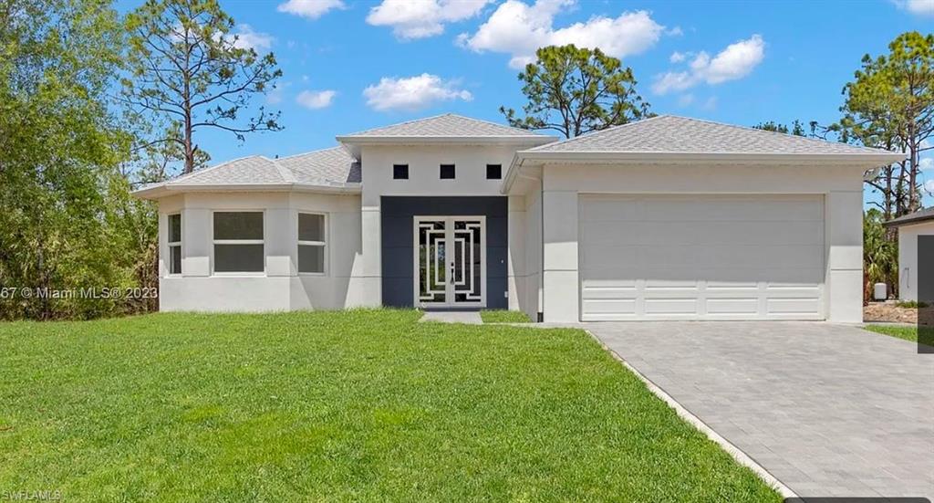 Prairie-style house featuring a garage and a front lawn