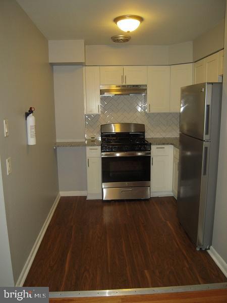 a kitchen with a refrigerator and a stove