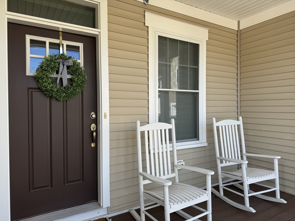 a view of porch with a chair and a potted plant