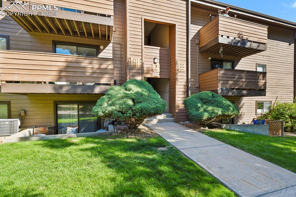 a view of a house with a yard and sitting area